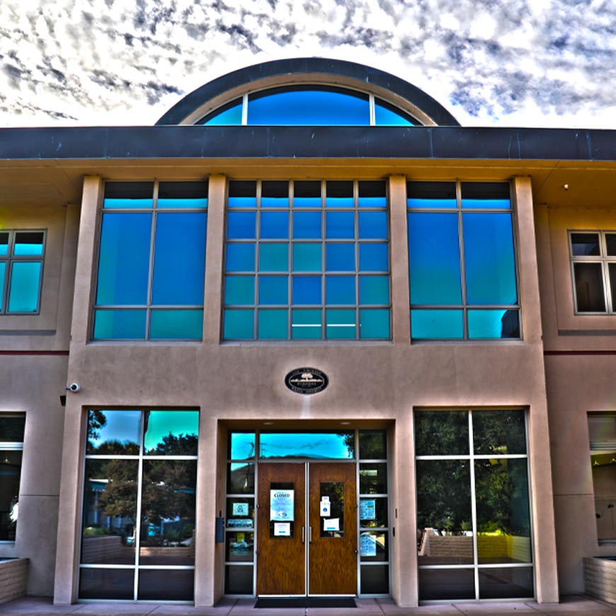 LVMWD HQ with closed sign on door clouds in background